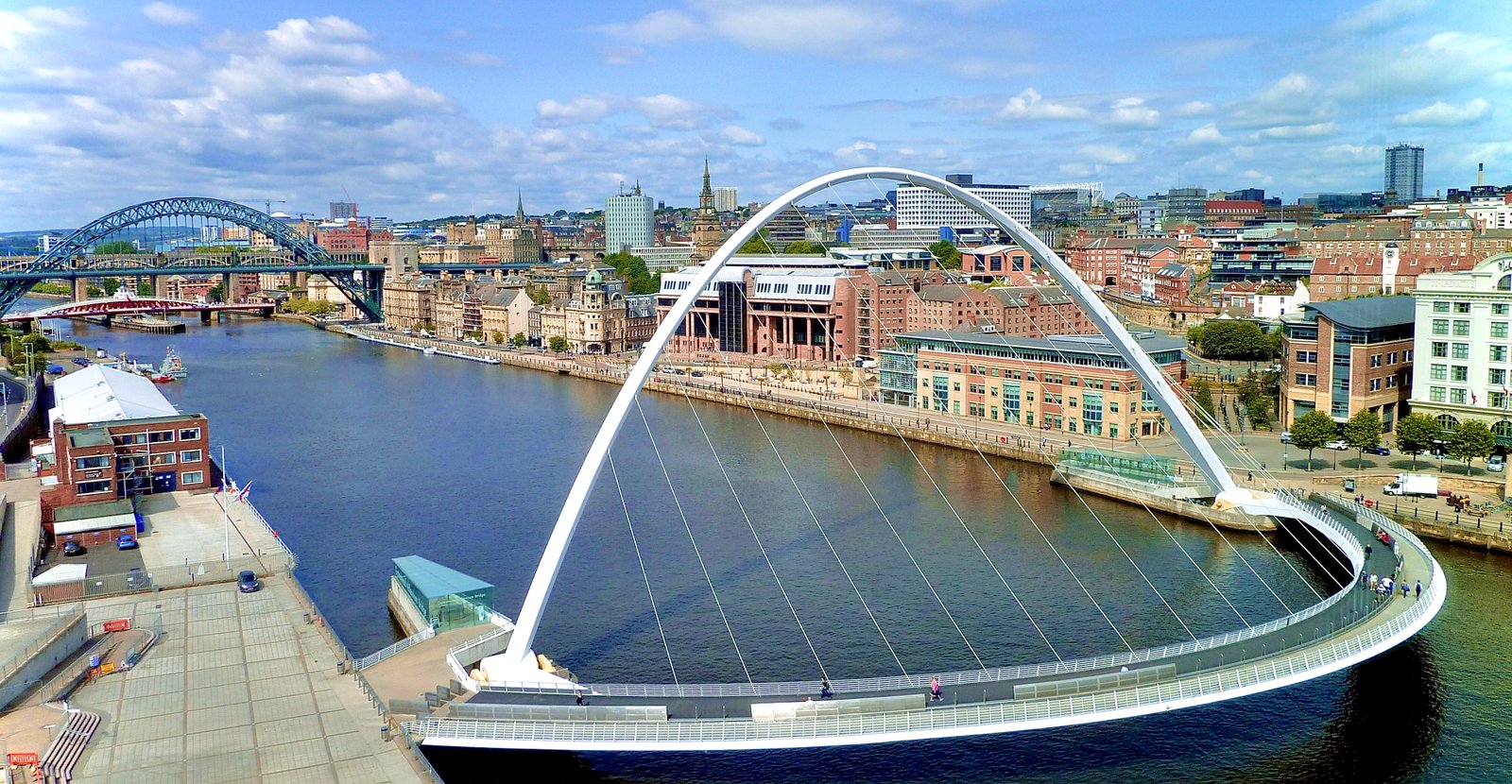 Gateshead Millennium Bridge tilting over River Tyne with Newcastle skyline
